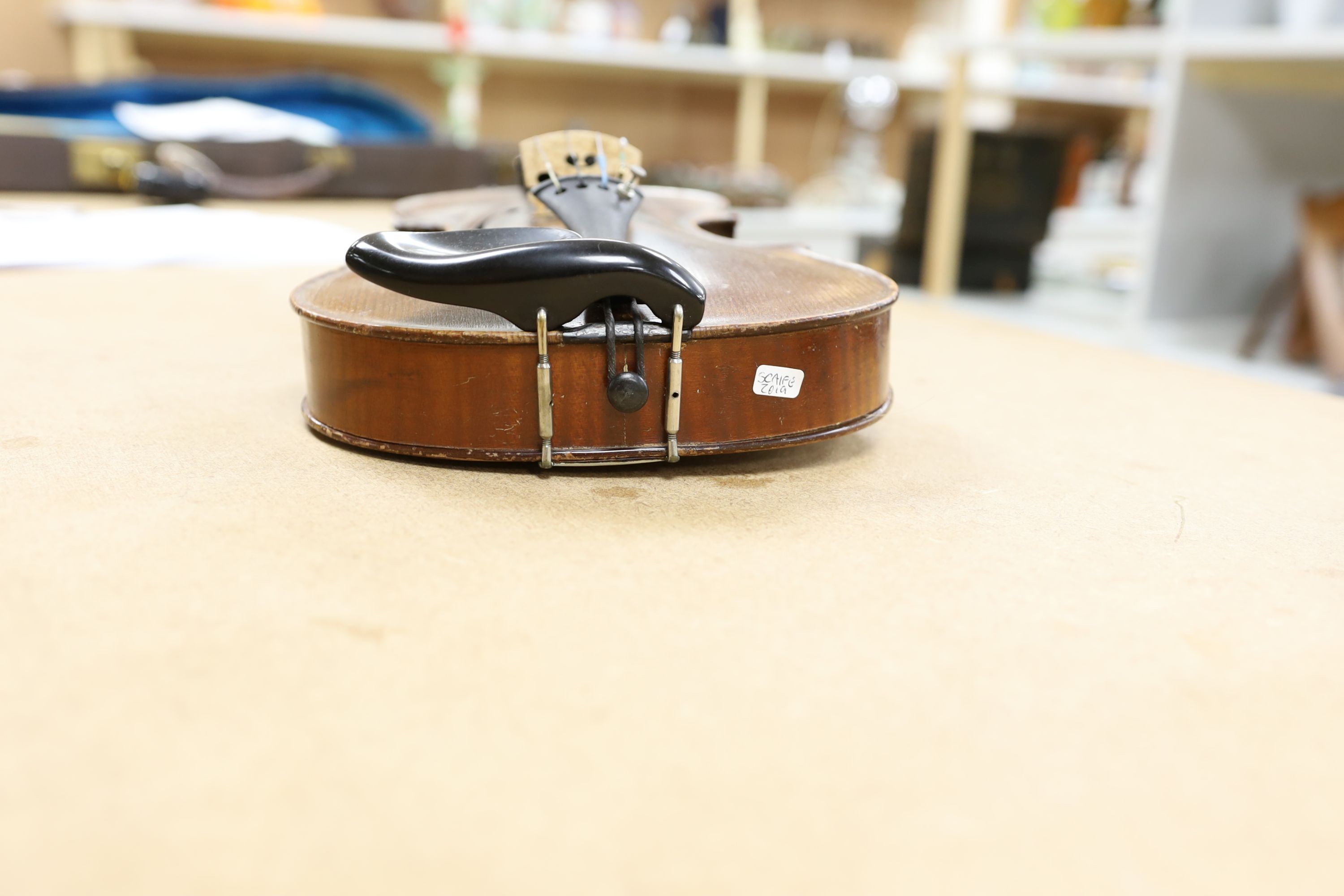 A cased violin, with bow